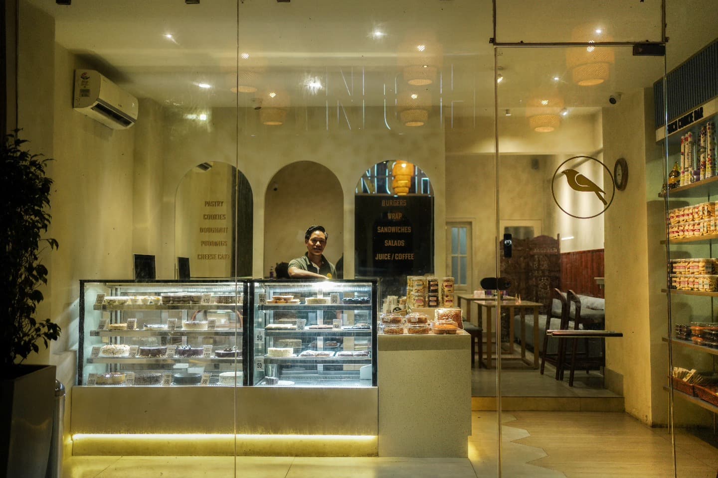Finch Cafe N Cakes counter with display cases and warm lighting