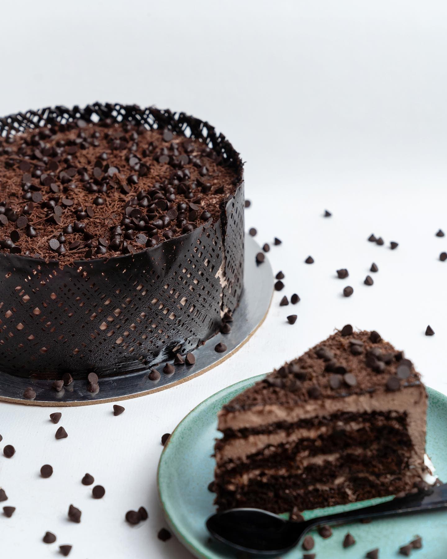Chocolate cake slice beside a full cake